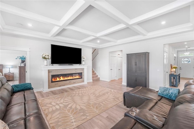 34655 N Legends Way, Grafton, OH 44044 - living room featuring light wood-type flooring, a tiled fireplace, coffered ceiling, beam ceiling, and recessed lighting