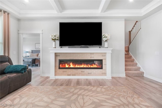 34655 N Legends Way, Grafton, OH 44044 - living room with a glass covered fireplace, wood finished floors, stairs, and beam ceiling