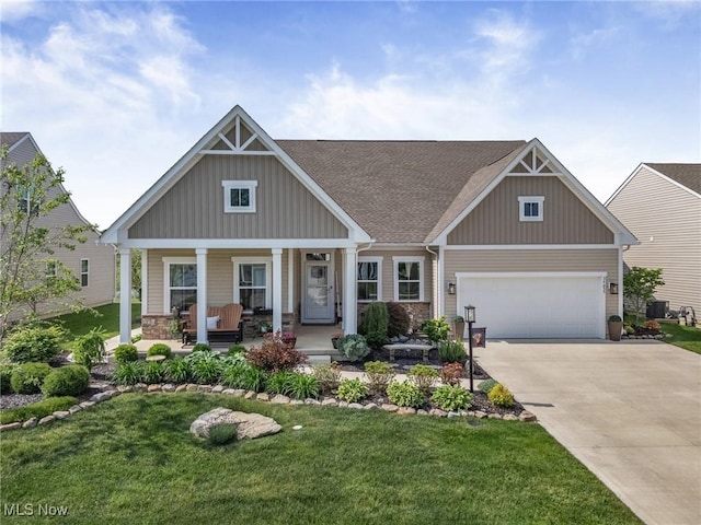 34655 N Legends Way, Grafton, OH 44044 - craftsman house featuring board and batten siding, a porch, concrete driveway, a front yard, and a garage