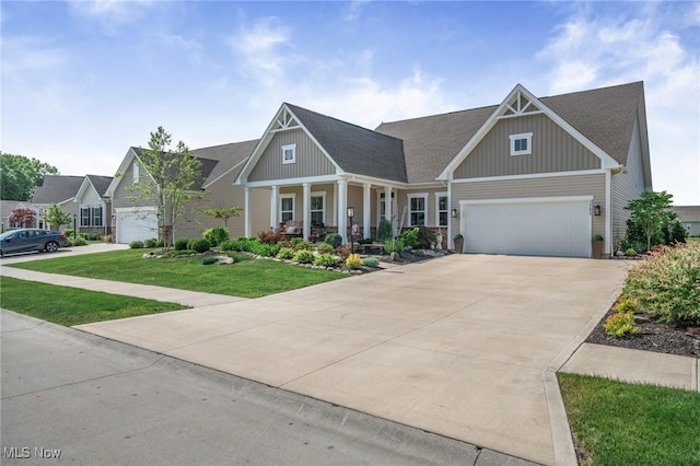 34655 N Legends Way, Grafton, OH 44044 - craftsman-style home with board and batten siding, a porch, driveway, a front yard, and an attached garage