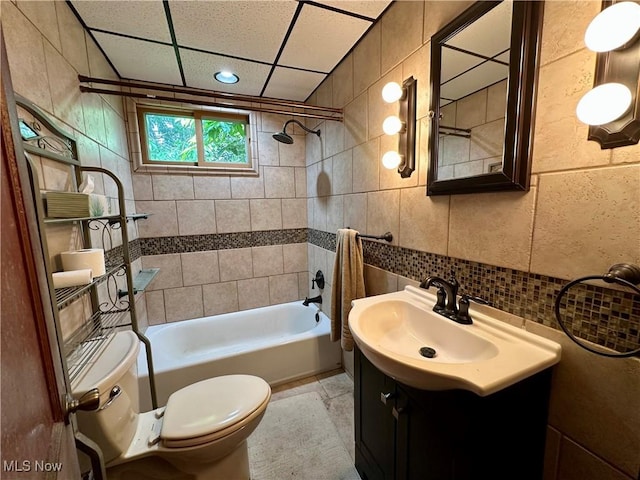 102 Wylie Dr, Short Creek, WV 26058 - bathroom with tile walls, toilet, vanity, tub / shower combination, and decorative backsplash