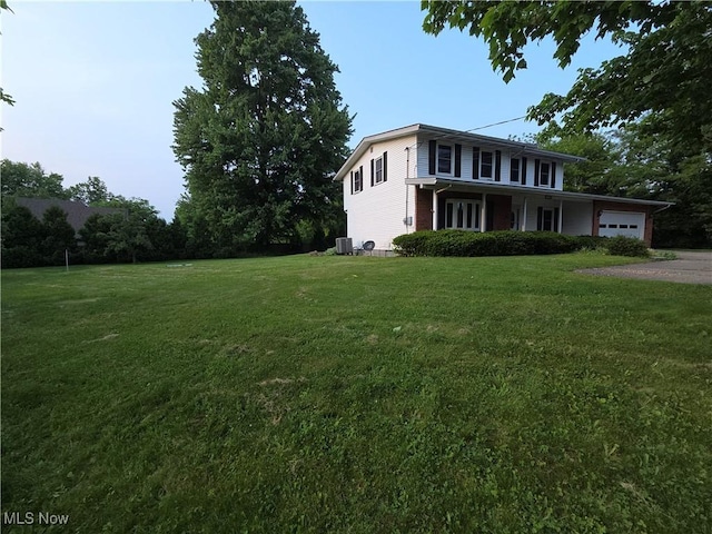 1025 S Ridge Rd, Geneva, OH 44041 - view of front of property featuring a garage, a front yard, cooling unit, and driveway