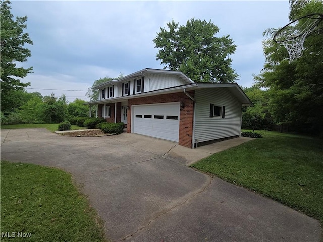 1025 S Ridge Rd, Geneva, OH 44041 - traditional-style house with concrete driveway, brick siding, a front yard, and a garage