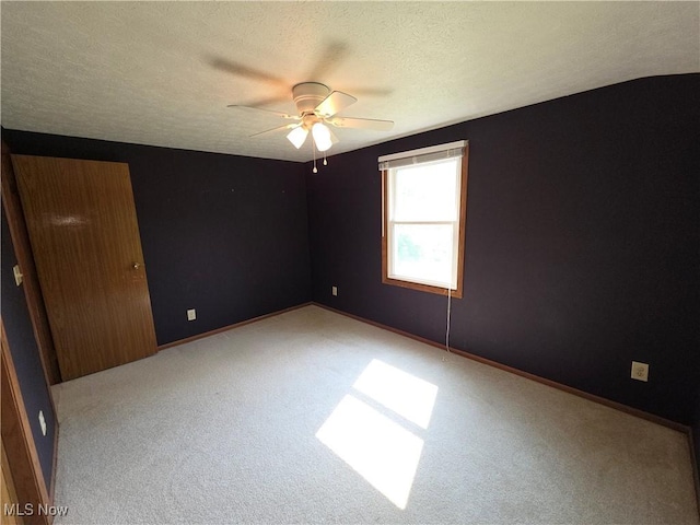 1025 S Ridge Rd, Geneva, OH 44041 - carpeted empty room featuring a ceiling fan, a textured ceiling, and baseboards