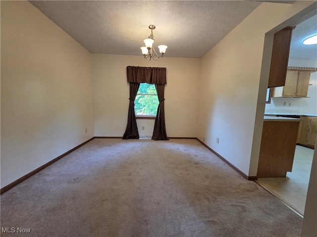 1025 S Ridge Rd, Geneva, OH 44041 - unfurnished dining area with a chandelier, light carpet, baseboards, and a textured ceiling