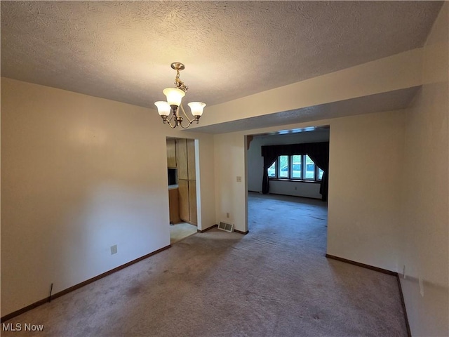 1025 S Ridge Rd, Geneva, OH 44041 - carpeted spare room featuring a chandelier, baseboards, and a textured ceiling