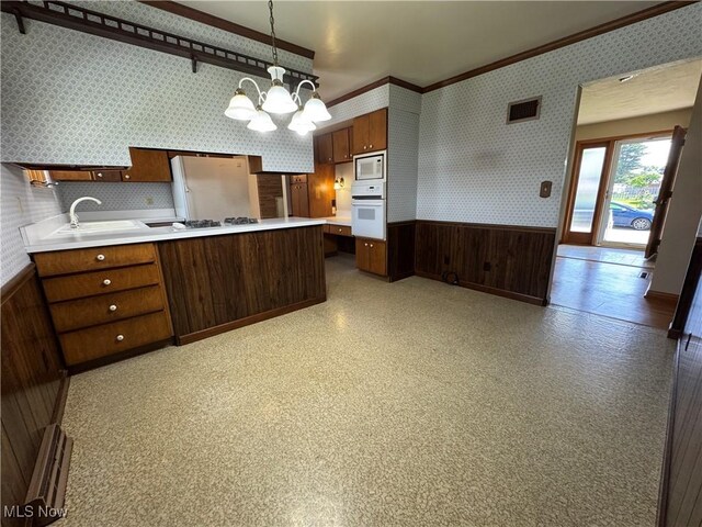 158 Main St, Rayland, OH 43943 - kitchen with wallpapered walls, white appliances, a wainscoted wall, a sink, and light countertops