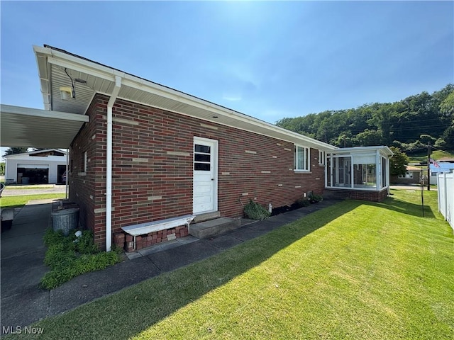 158 Main St, Rayland, OH 43943 - view of property exterior featuring entry steps, brick siding, and a sunroom