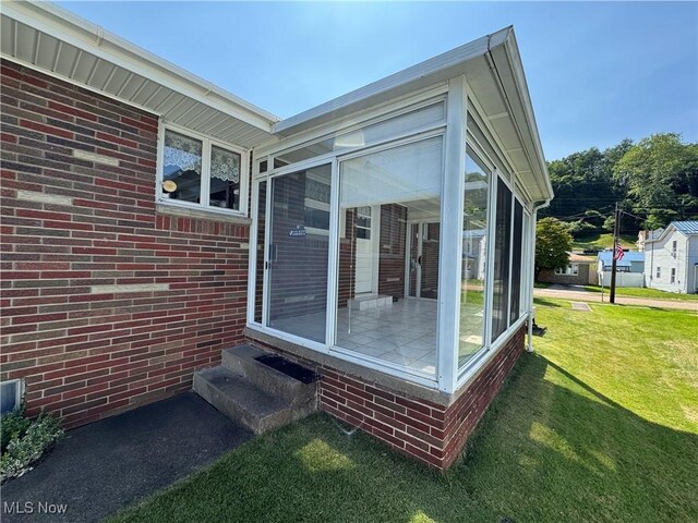 158 Main St, Rayland, OH 43943 - exterior space with a sunroom, entry steps, and a lawn