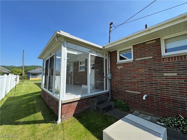 158 Main St, Rayland, OH 43943 - view of side of property featuring a sunroom, entry steps, and brick siding