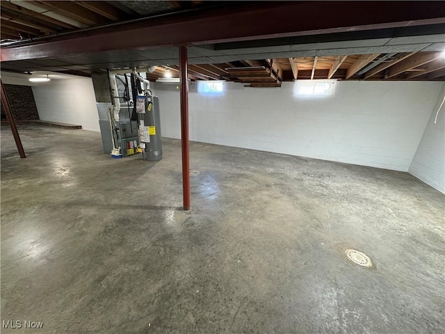 158 Main St, Rayland, OH 43943 - below grade area featuring water heater, heating unit, and concrete block wall