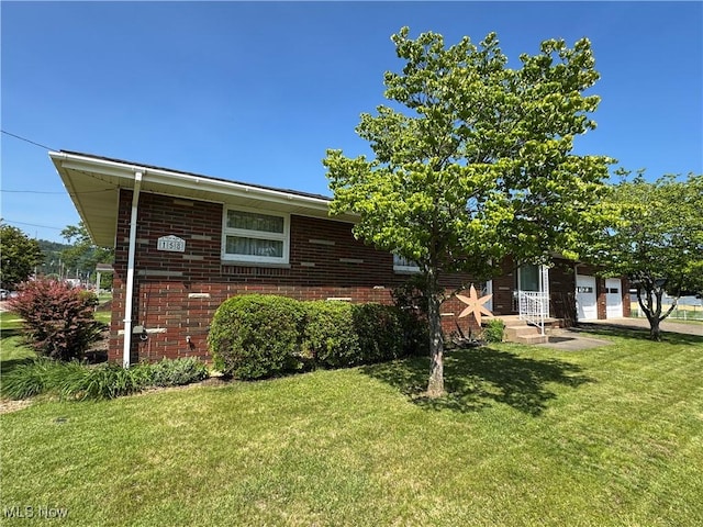 158 Main St, Rayland, OH 43943 - view of front of property featuring a front yard, a garage, and brick siding