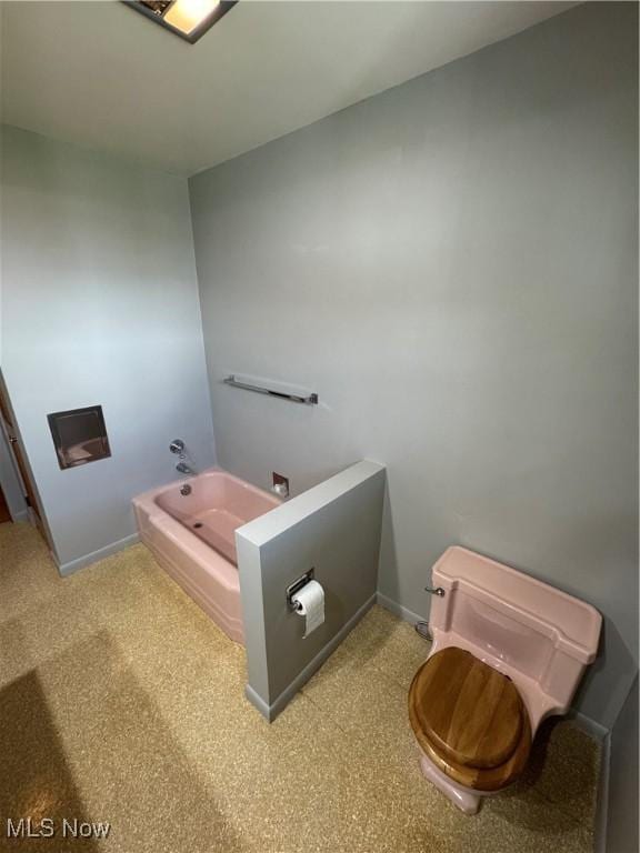 158 Main St, Rayland, OH 43943 - bathroom featuring a bath, carpet floors, baseboards, and toilet