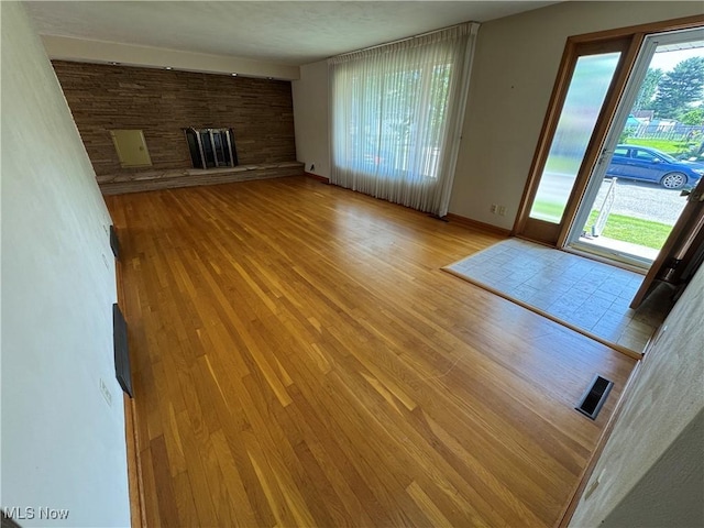 158 Main St, Rayland, OH 43943 - unfurnished living room with wood finished floors, healthy amount of natural light, and baseboards