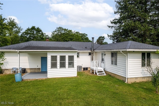 4855 Lake Dawn Dr, Medina, OH 44256 - rear view of house featuring a lawn, a patio area, a shingled roof, central AC, and a chimney