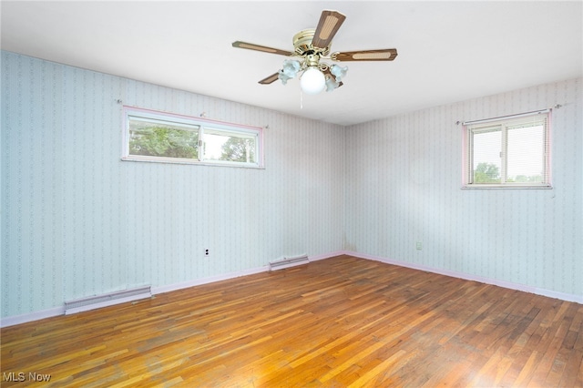 4855 Lake Dawn Dr, Medina, OH 44256 - unfurnished room with wood-type flooring, healthy amount of natural light, a ceiling fan, and a baseboard heating unit