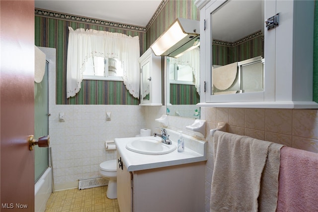 4855 Lake Dawn Dr, Medina, OH 44256 - full bath featuring wallpapered walls, vanity, toilet, tile walls, and bath / shower combo with glass door