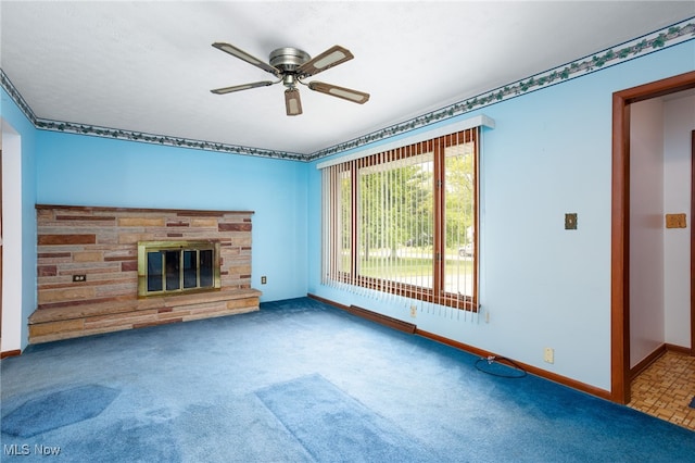 4855 Lake Dawn Dr, Medina, OH 44256 - unfurnished living room featuring ceiling fan, baseboards, a stone fireplace, and carpet