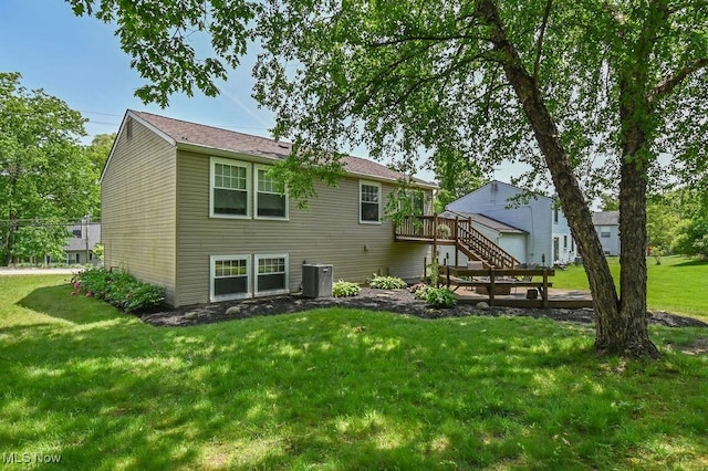 2610 Norton Rd, Stow, OH 44224 - back of property with a wooden deck, cooling unit, stairway, and a lawn