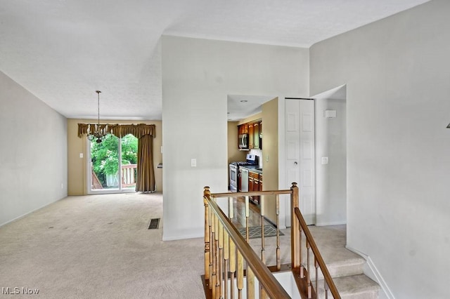 2610 Norton Rd, Stow, OH 44224 - corridor with light carpet, a chandelier, an upstairs landing, and baseboards