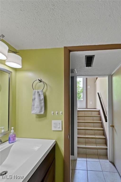 2610 Norton Rd, Stow, OH 44224 - bathroom featuring vanity, a textured ceiling, and tile patterned flooring