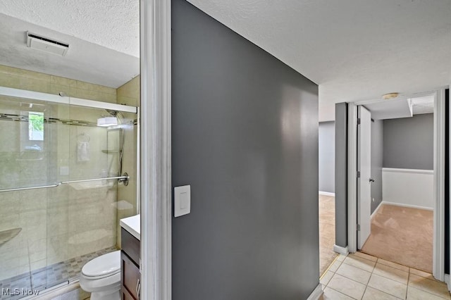 2610 Norton Rd, Stow, OH 44224 - bathroom with tile patterned flooring, toilet, a shower stall, vanity, and a textured ceiling