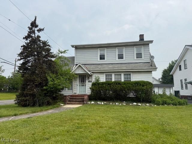 13603 Alvin Ave, Garfield Heights, OH 44105 - traditional-style house with a chimney and a front lawn