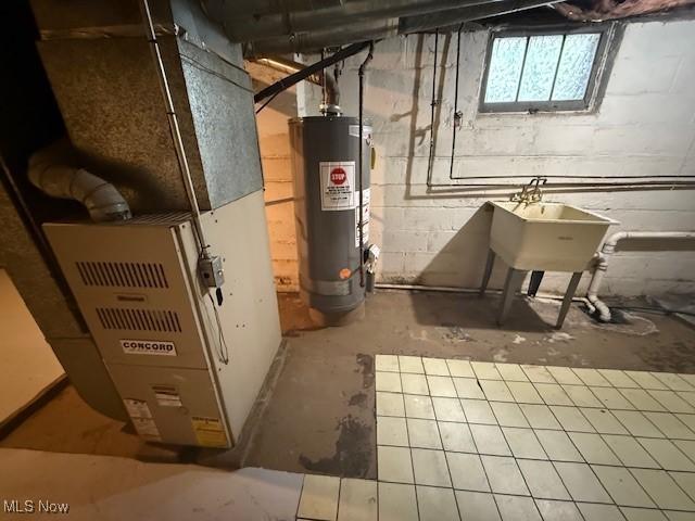 13603 Alvin Ave, Garfield Heights, OH 44105 - basement featuring gas water heater, heating unit, and a sink