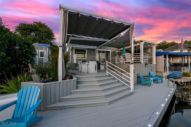 552 Saunders Ave, Akron, OH 44319 - back of house at dusk featuring a wooden deck and stairs