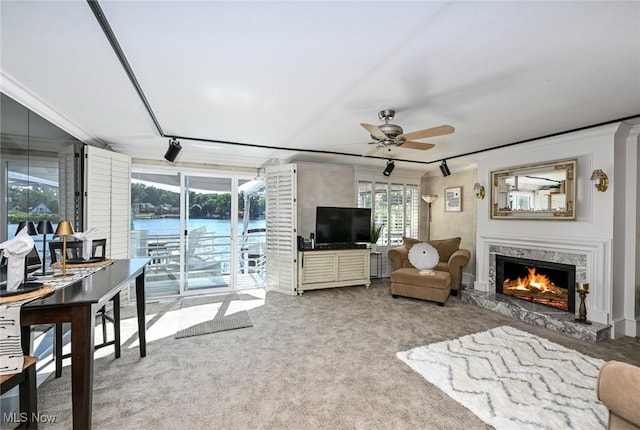 552 Saunders Ave, Akron, OH 44319 - living room with a ceiling fan, carpet, a fireplace, and crown molding