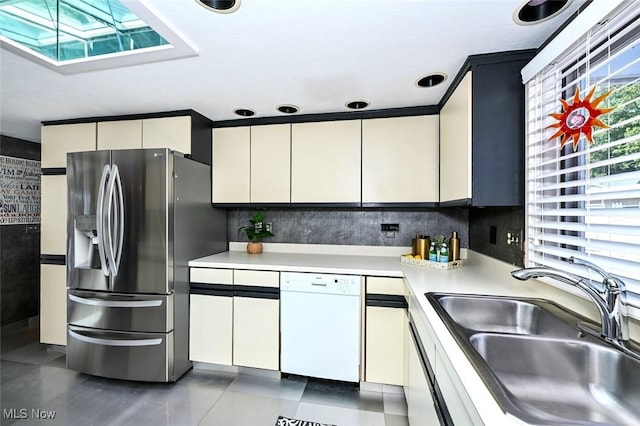 552 Saunders Ave, Akron, OH 44319 - kitchen featuring white dishwasher, stainless steel fridge with ice dispenser, a skylight, a sink, and light countertops