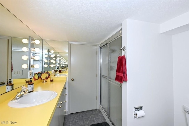 552 Saunders Ave, Akron, OH 44319 - full bath featuring vanity, a stall shower, a textured ceiling, and toilet