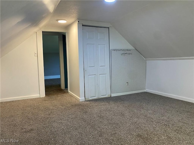 10919 Geib Ave NE, Hartville, OH 44632 - additional living space featuring carpet, vaulted ceiling, and baseboards