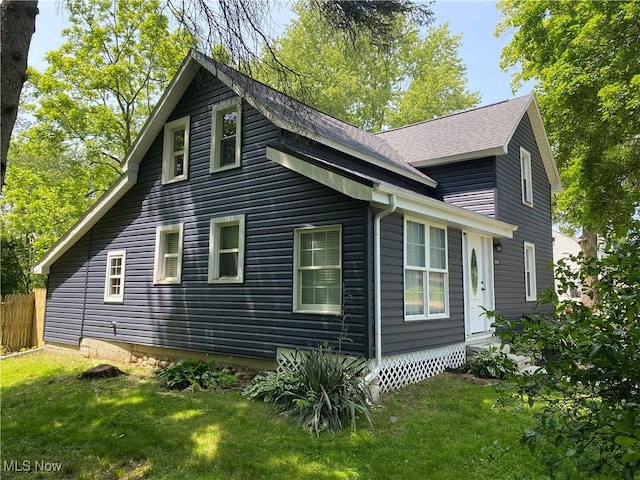 10919 Geib Ave NE, Hartville, OH 44632 - view of side of property featuring a yard and a shingled roof