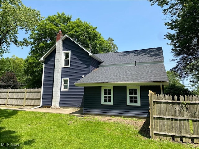 10919 Geib Ave NE, Hartville, OH 44632 - rear view of house with a shingled roof and a chimney