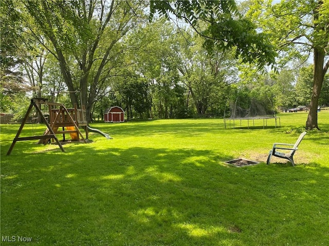 10919 Geib Ave NE, Hartville, OH 44632 - view of green lawn with a trampoline and a playground