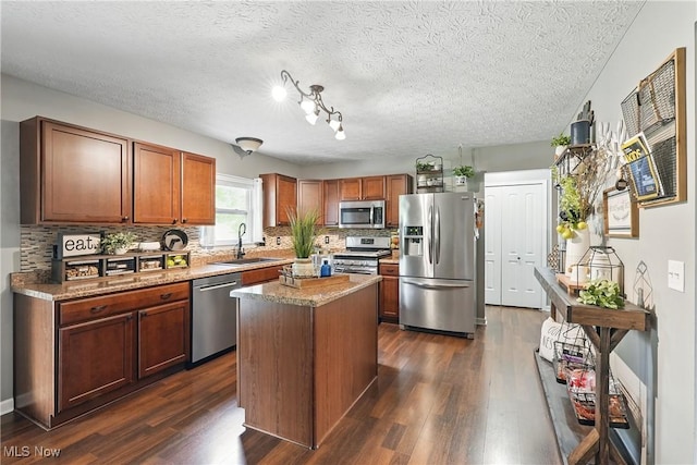 5380 Grovewood Ln, Medina, OH 44256 - kitchen featuring appliances with stainless steel finishes, a sink, decorative backsplash, dark wood-type flooring, and brown cabinetry