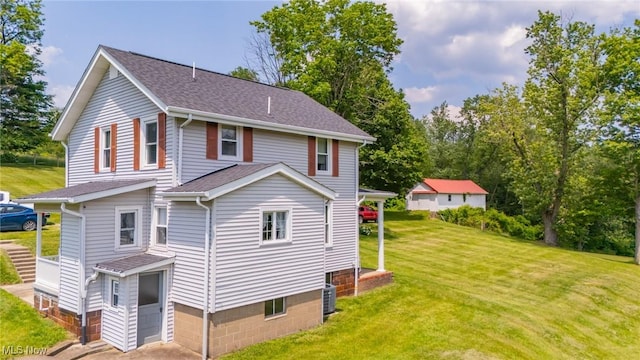 51300 Wegee Rd, Bellaire, OH 43906 - view of front of property with central AC, a front lawn, and roof with shingles