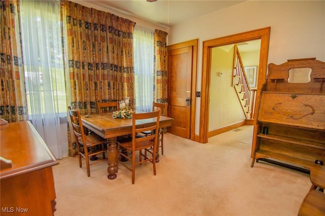 51300 Wegee Rd, Bellaire, OH 43906 - dining area featuring light carpet, stairway, and baseboards