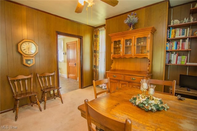 51300 Wegee Rd, Bellaire, OH 43906 - dining area featuring a ceiling fan, ornamental molding, wooden walls, and light colored carpet