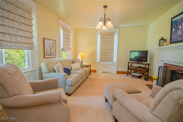 51300 Wegee Rd, Bellaire, OH 43906 - carpeted living room with a chandelier, a fireplace with flush hearth, and baseboards