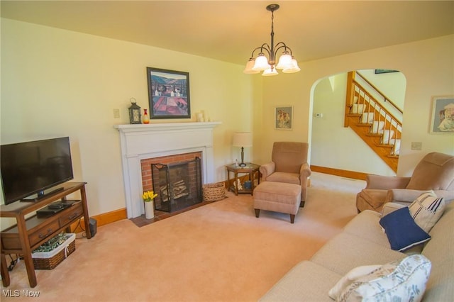 51300 Wegee Rd, Bellaire, OH 43906 - carpeted living area with arched walkways, stairs, a fireplace, baseboards, and a chandelier