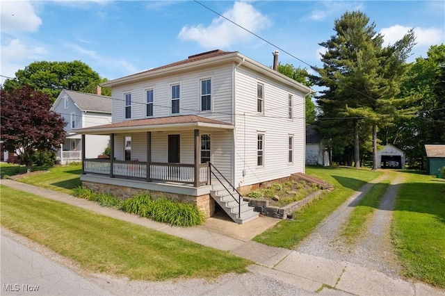 104 W Schultz St, Dalton, OH 44618 - view of front facade featuring a porch, driveway, a front yard, and an outdoor structure