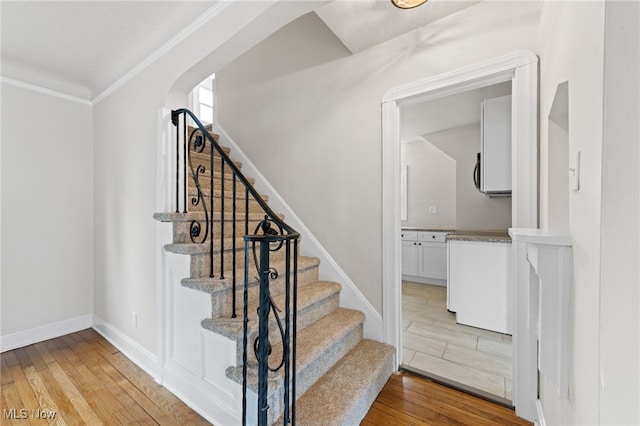 3497 Raymont Blvd, University Heights, OH 44118 - stairs featuring wood finished floors, crown molding, arched walkways, and baseboards