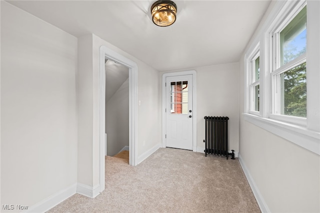 3497 Raymont Blvd, University Heights, OH 44118 - spare room with radiator, light colored carpet, and baseboards