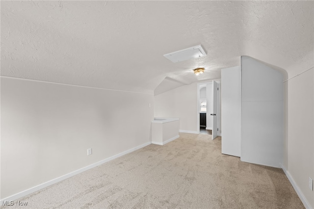 3497 Raymont Blvd, University Heights, OH 44118 - additional living space with a textured ceiling, lofted ceiling, light carpet, and baseboards