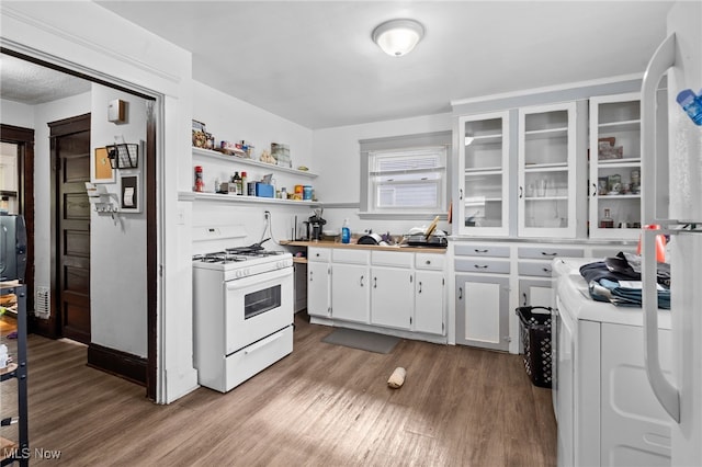 14520 Bayes Ave, Lakewood, OH 44107 - kitchen with white range with gas stovetop, wood finished floors, white cabinetry, and glass insert cabinets