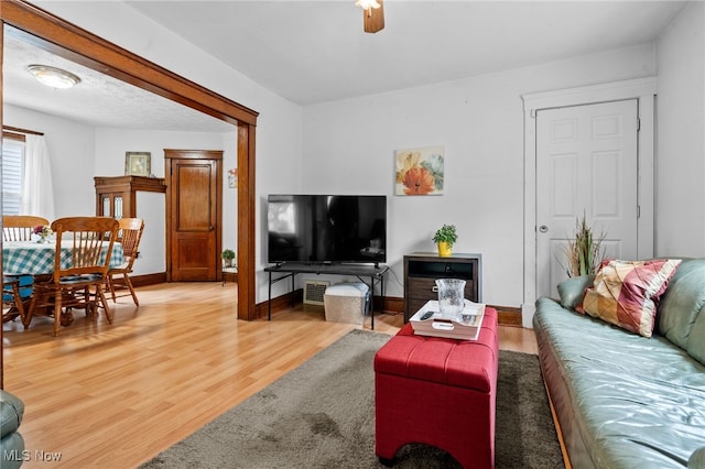 14520 Bayes Ave, Lakewood, OH 44107 - living room featuring light wood-style floors, baseboards, and a ceiling fan