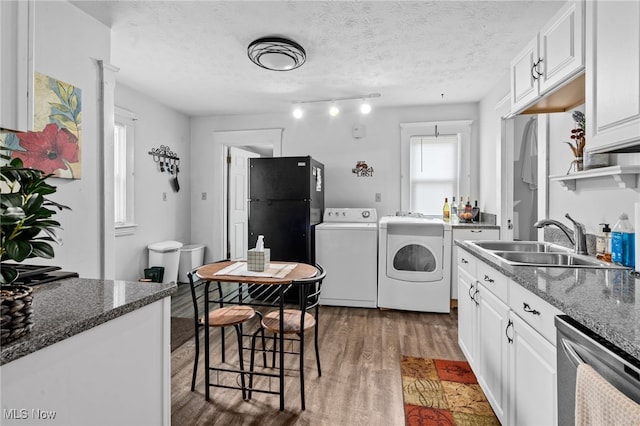14520 Bayes Ave, Lakewood, OH 44107 - kitchen with separate washer and dryer, freestanding refrigerator, a sink, light wood-style floors, and dishwasher