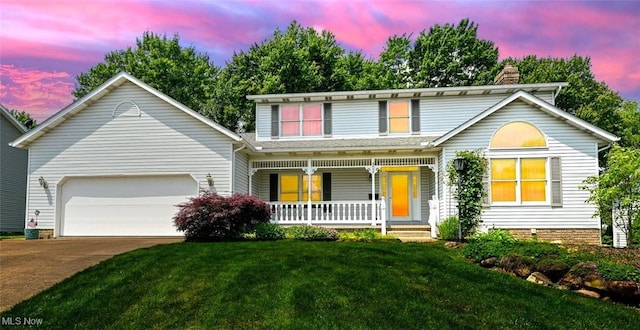 452 Herbert Rd, Akron, OH 44312 - traditional-style house with a porch, a chimney, driveway, a garage, and a lawn